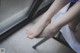 A woman sitting on a chair with her feet up.