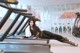 A woman laying on a treadmill in a gym.