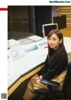 A woman sitting at a desk in front of a computer.