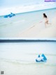 A woman in a bikini running on the beach with an inflatable shark.